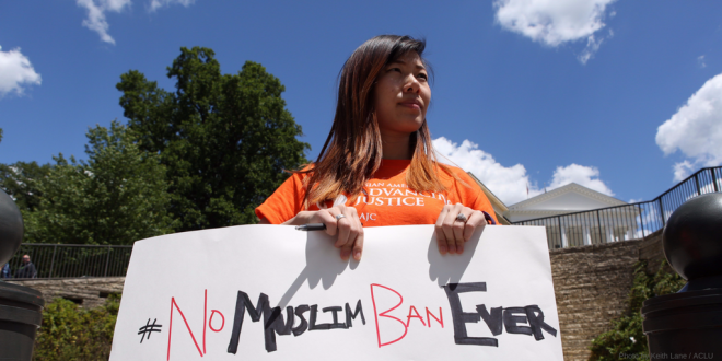 Woman holding No Muslim Ban sign
